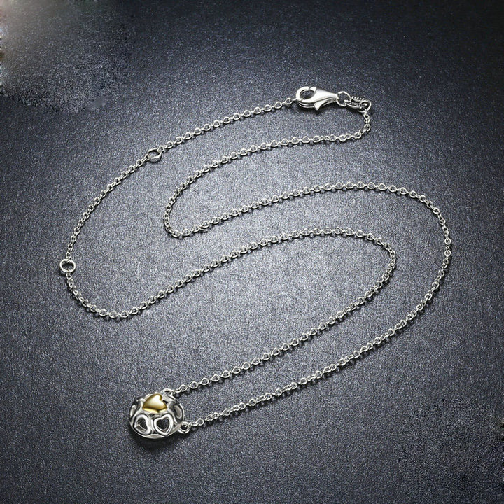 "Helia" - Zarte Halskette mit hohlen Herz- und Kugel-Elementen aus 925er Silber