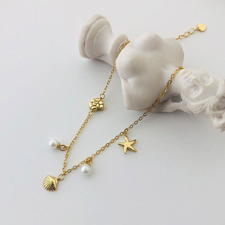 "Oravina"- Armband mit goldenem Seestern, Muschel und Perlen aus 925er Sterlingsilber